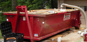 webringinthedumpsterandhaveitsetonplywoodthatwepreplaceinordertoprotectthedrivewayfromscratches..jpg